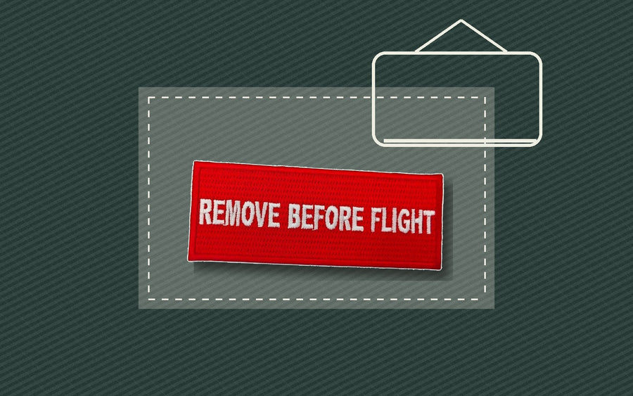 Iron-on patch positioned on fabric with a pressing cloth and iron outline