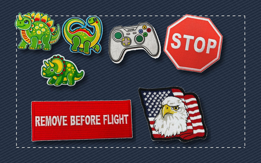 Assorted iron-on patches arranged on fabric for placement ideas