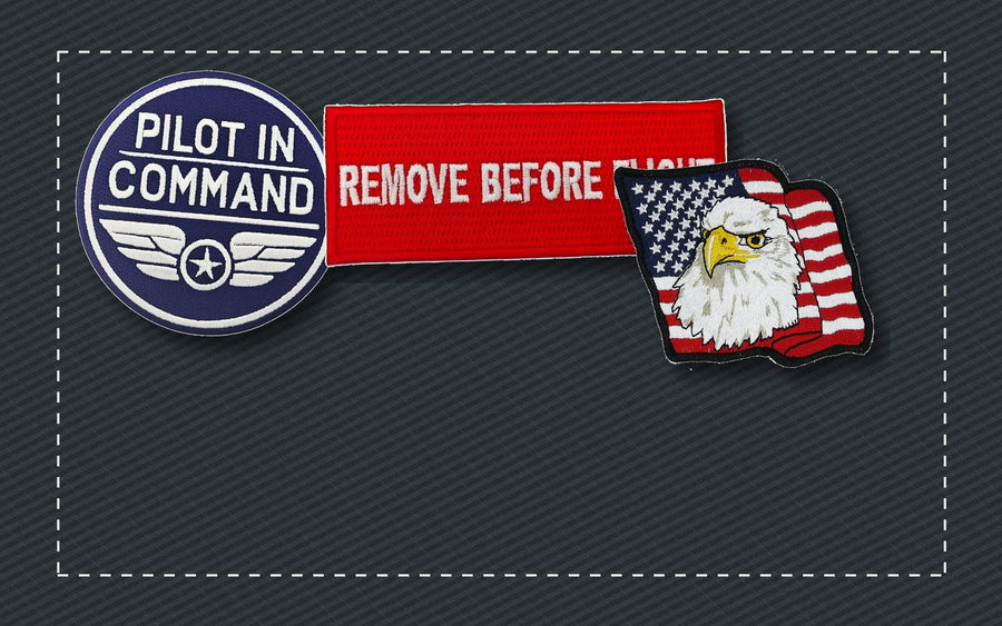 Embroidered aviation, workwear, and flag patches arranged on dark fabric