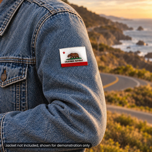 California flag patch on a denim jacket sleeve on a coastal road at sunset